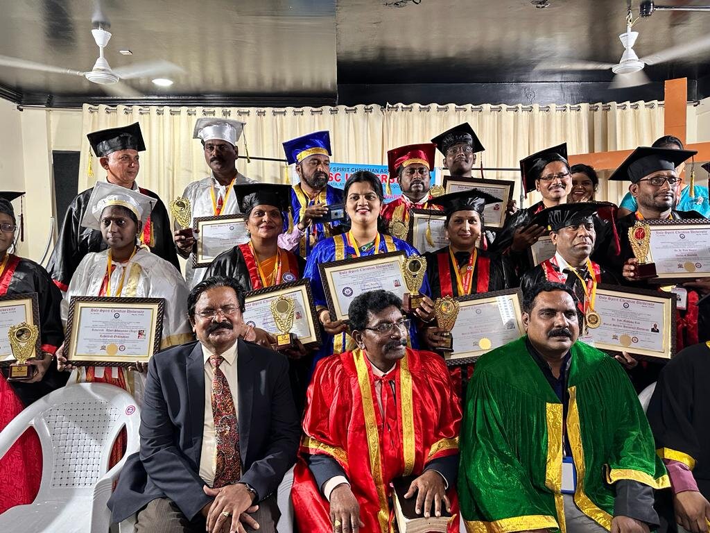 Award recipients holding certificates and trophies on stage