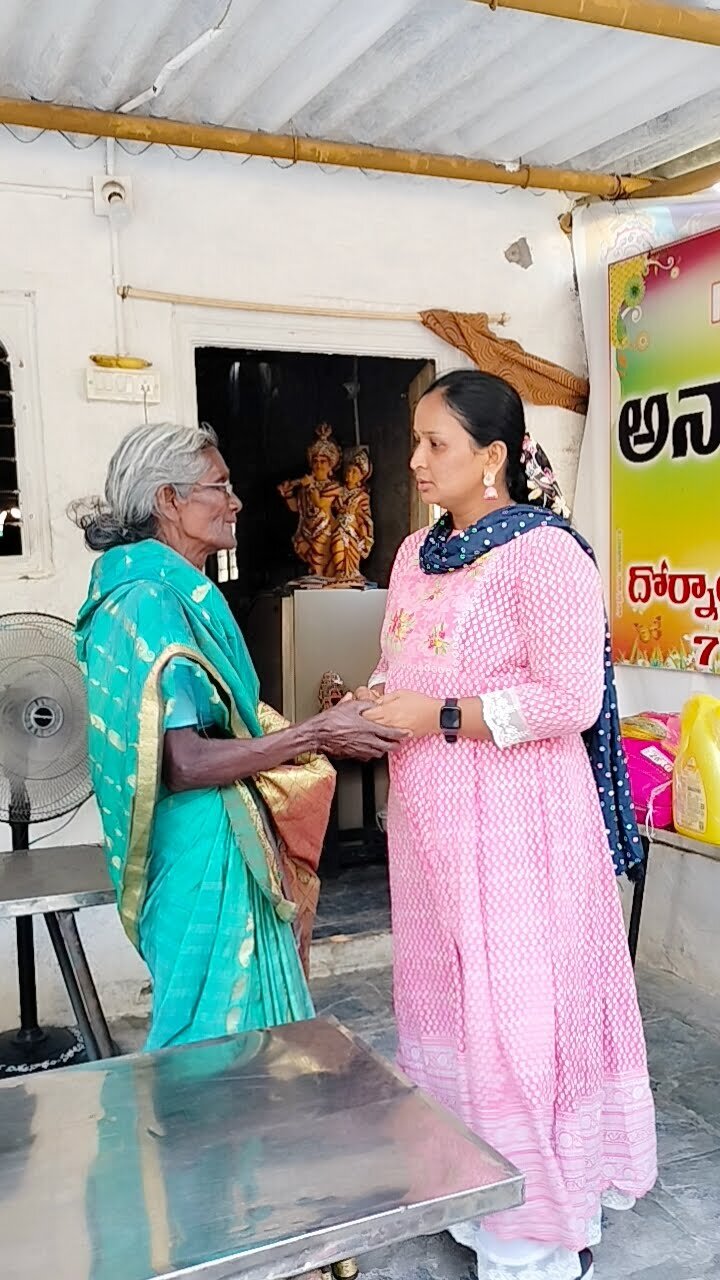 Elderly woman greeting a foundation volunteer